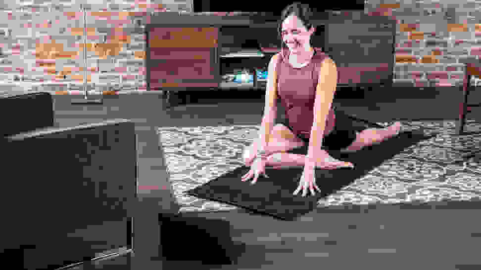Woman practicing yoga at home.