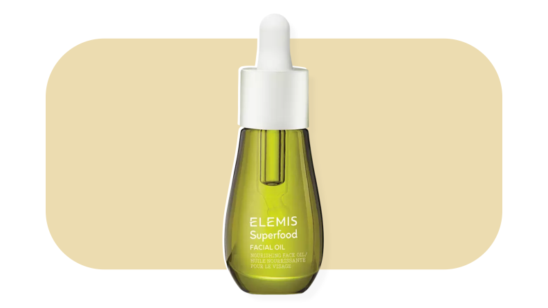 Elemis face oil in front of a mustard-colored background.