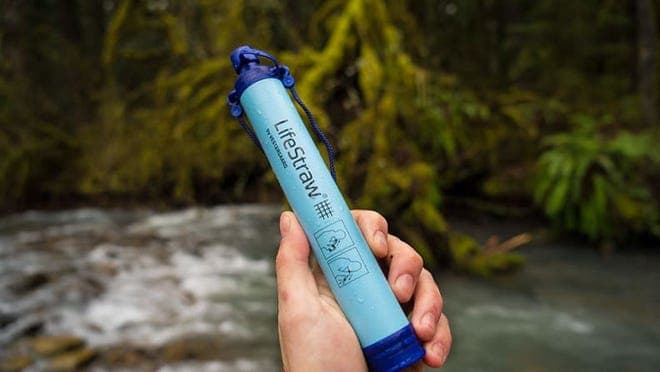 A person holds a LifeStraw water filter