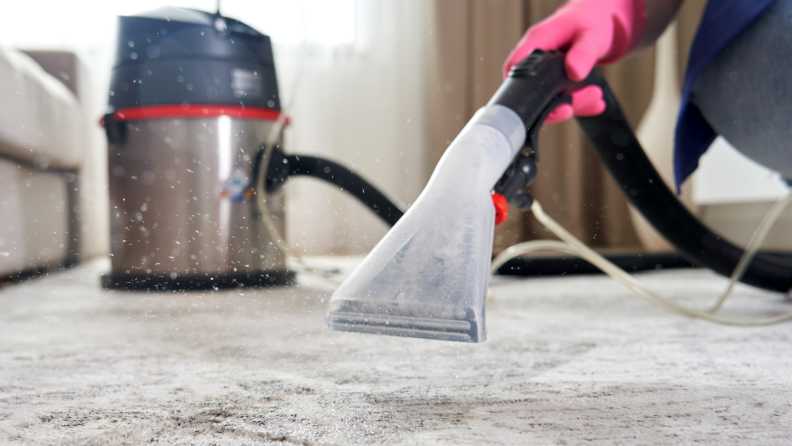 Person using carpet cleaner