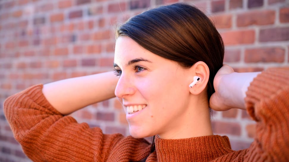 A woman wearing a pair of Apple AirPod Pro wireless earbuds.