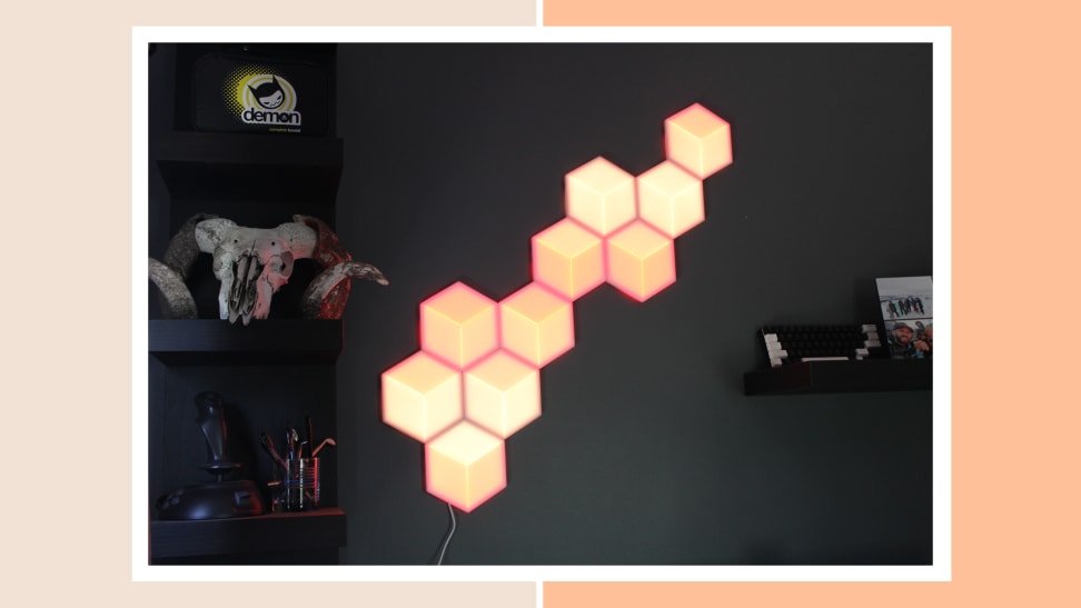 Govee Hexagon Lights mounted on wall in living room next to book case.