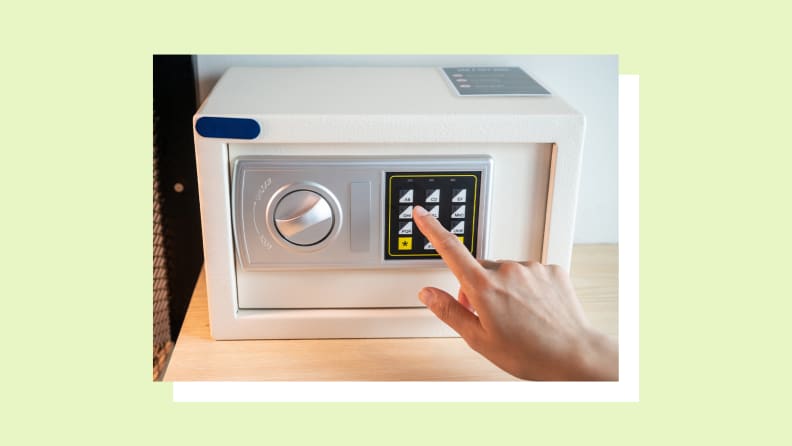 Person pressing buttons on small personal safe.