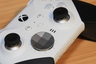 Close up view of a white xbox elite 2 core controller with black grips