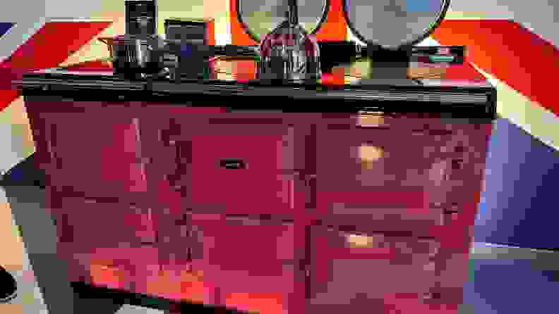 Pink cast iron range with cookware on top