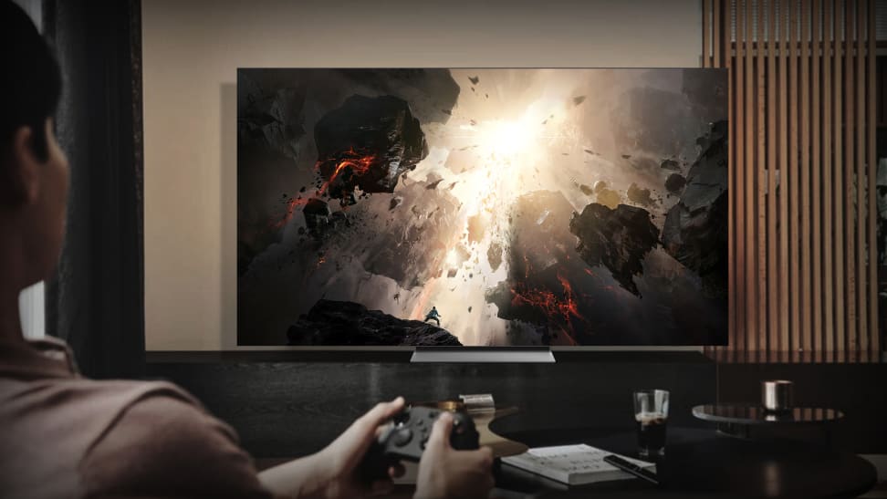 The 76-inch Samsung MicroLED CX TV displaying video game concept art, staged in a living room setting