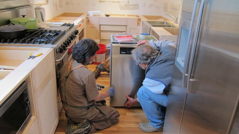 Men installing a dishwasher