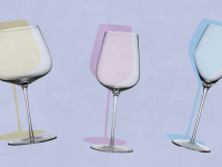 A yellow red wine glass, a pink white wine glass and a blue champagne glass sit next to each other on a lavender background.