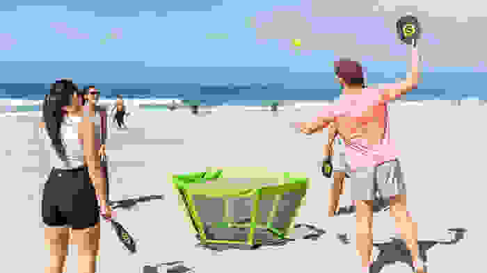 people playing game on beach