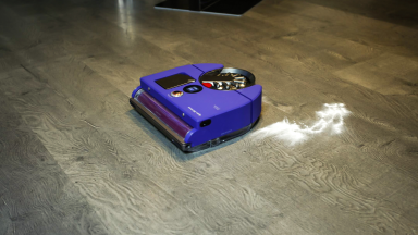 The Dyson 360 Vis Nav robot vacuum cleaning baby powder off a hardwood floor