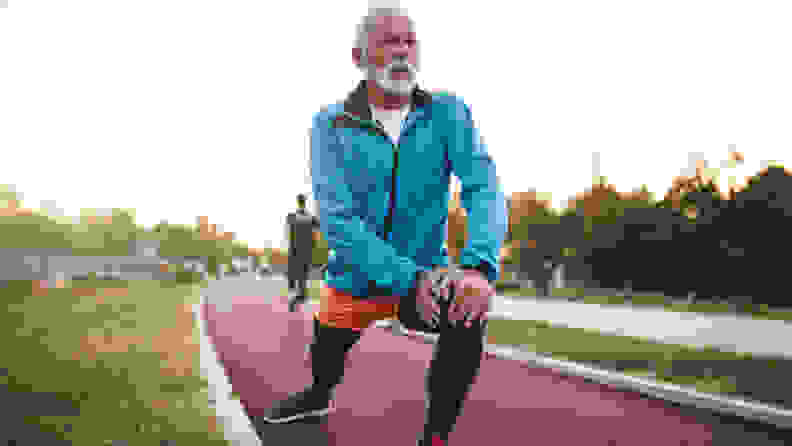 A man doing lunges on a track.