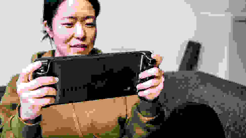 Woman using a handheld video game console