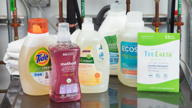 Eco-friendly laundry detergents sitting on top of a washer.