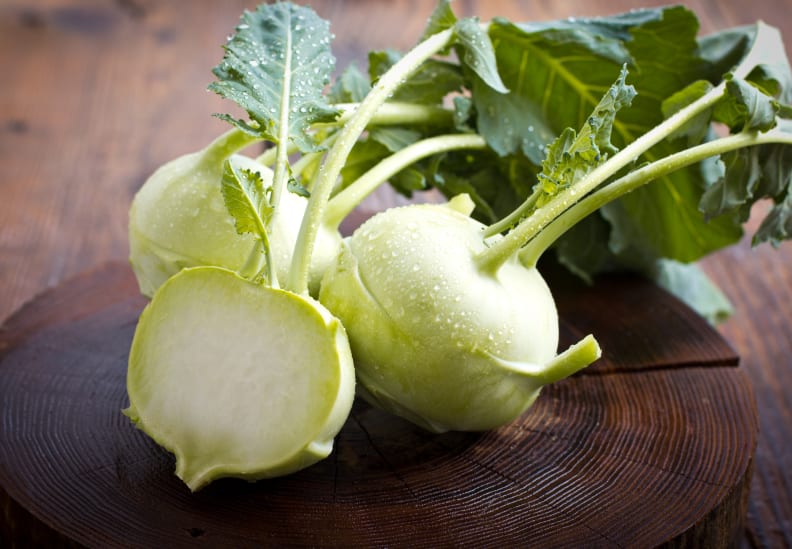 Fresh kohlrabi on the wooden table closeup.