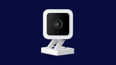 A midnight blue background surrounds a square, white camera on a stand.