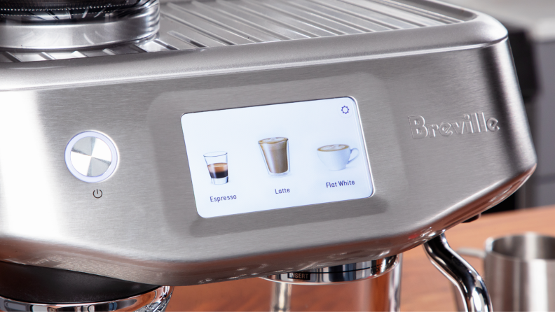 Touchscreen display on the Breville Barista Touch Impress espresso machine with pictures of espresso, latte and flat white coffees on screen.