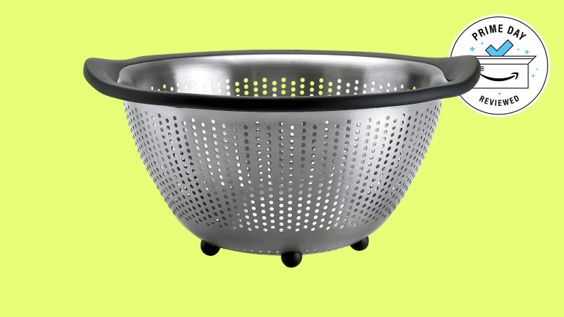 The OXO Good Grips Stainless Steel 5-Quart Colander against a yellow background.
