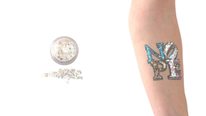 A dollop of makeup glitter added to a faux arm tattoo.