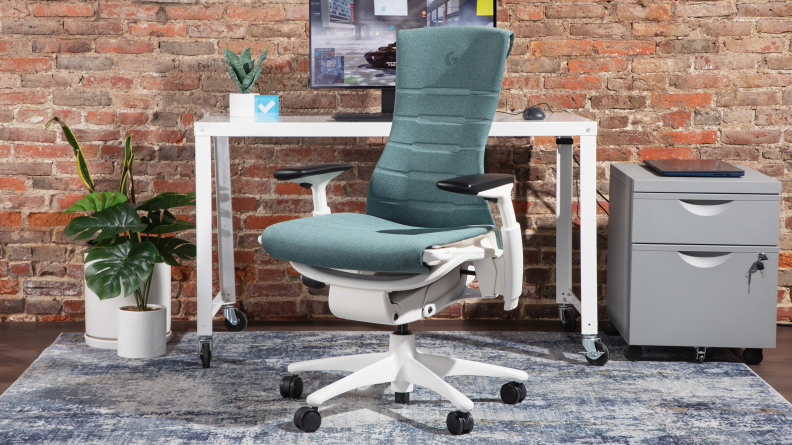 The herman miller x logitech g embody, one of the best gaming chairs you can buy right now, with white plastic base, green fabric, and aluminum frame