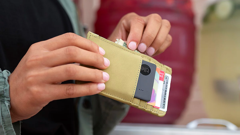 Person with a Tile tracker in their wallet