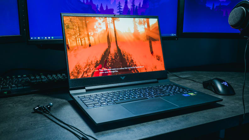 Laptop pictured on a desk under a light