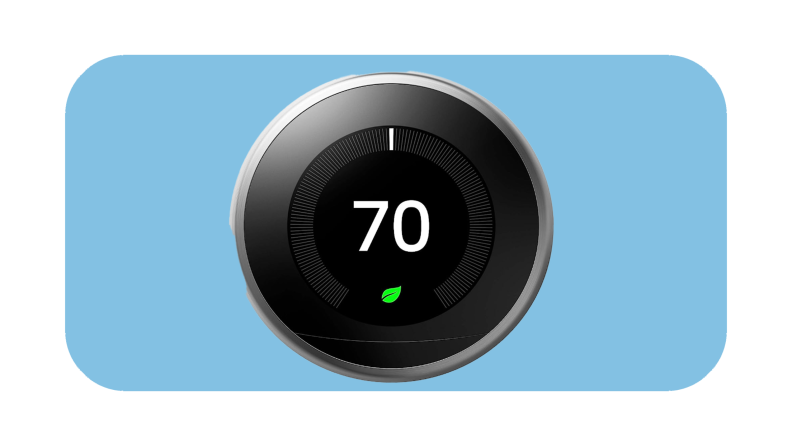 Round black and silver Google Nest thermostat with temperature on screen.