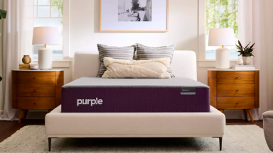 An image of a Purple RestorePlus Hybrid Mattress on a white bed frame.