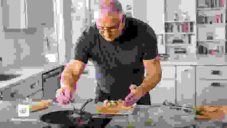 Robert Irvine cooking a meal in kitchen