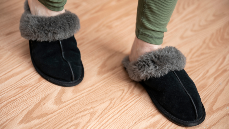 Person wearing gray fur lined Ugg Scuffette II slippers.