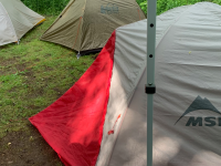 Backpacking tents being used by friends at a campsite.