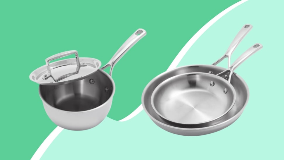 Sur La Table stainless steel saucepan (left) and skillet set (right) on a green background