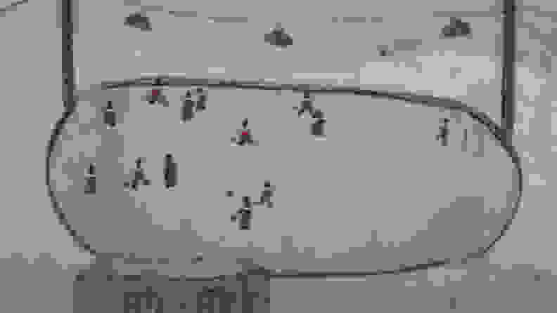 An animated frame of a hockey game on a frozen pond.