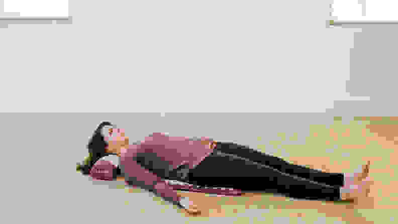 woman lying on kanjo acupressure mat.