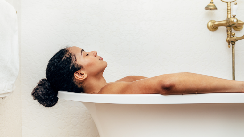 A woman taking a relaxing soak in a bathtub