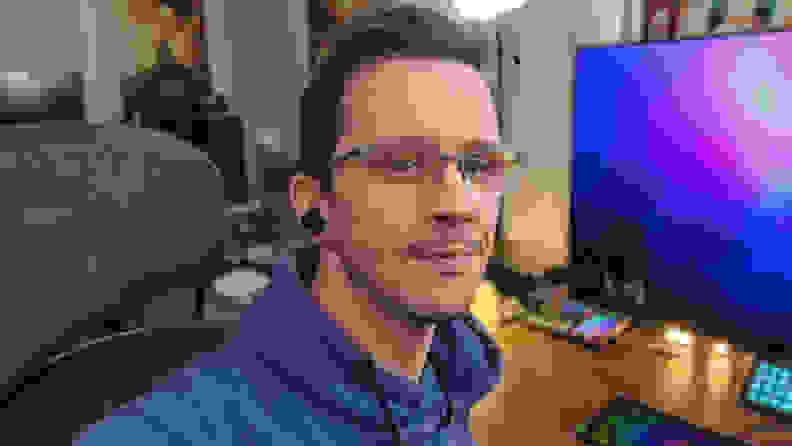 A man taking a selfie wearing the Sony Inzone Buds.