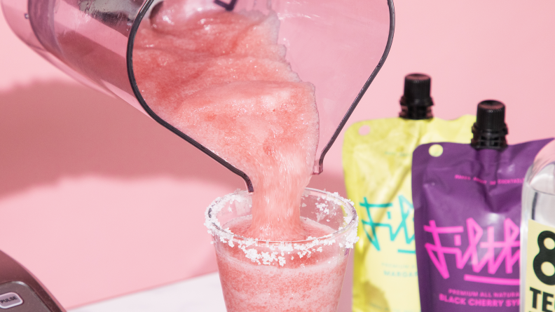 black cherry margarita mix being poured into cup
