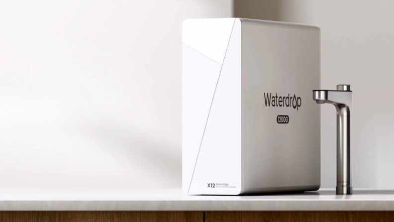 A Waterdrop RO system sits on a counter next to a smart faucet
