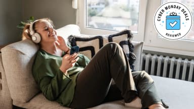 A woman listening to Amazon Music with a Cyber Monday logo in the corner.