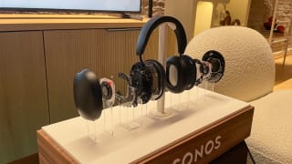 A Sonos headphone display with a pair of Sonos Ace headphones deconstructed to showcase each piece of hardware.