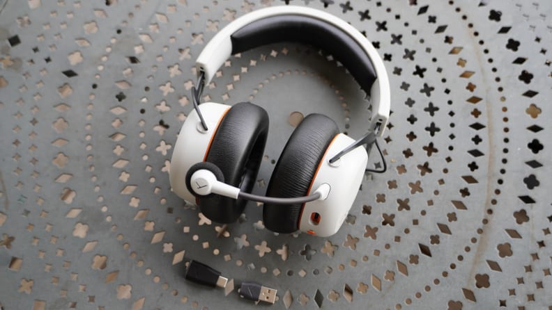 The Beyerdynamic MMX 200 headphones with a microphone on a black metal table.