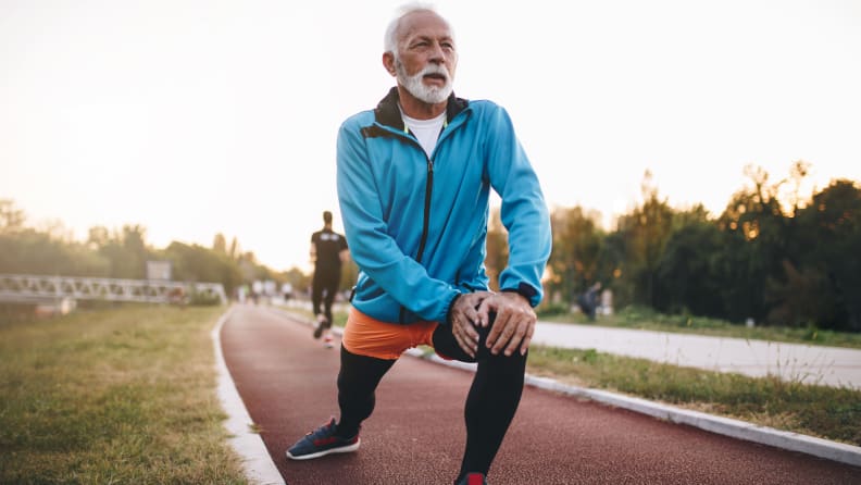 A man doing lunges on a track.