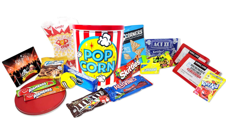 An assortment of candy and microwave popcorn for a movie night.