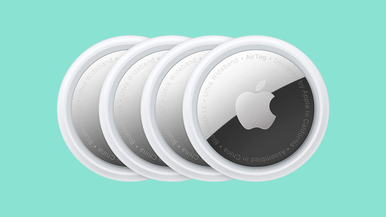 A four-pack of Apple AirTags on a turquoise background.