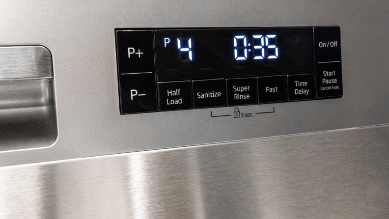 The front control panel of a stainless steel dishwasher has an LED light display