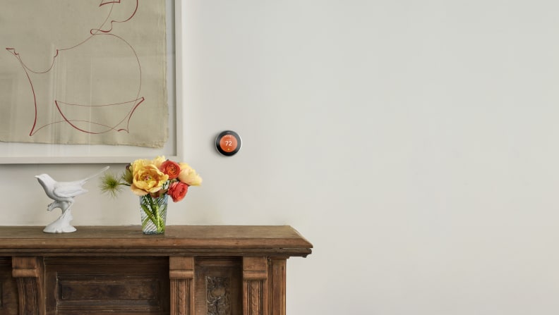 A shot of the Nest Learning Thermostat on the wall of a homey hallway.