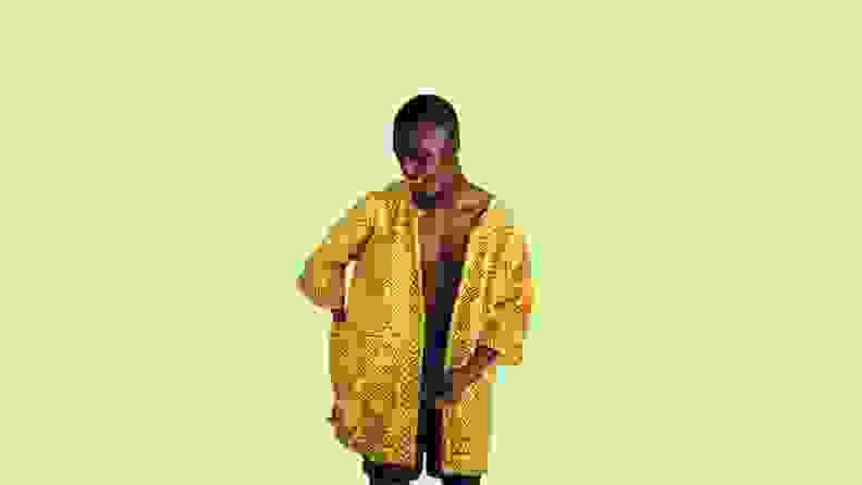 A yellow and black cloak modeled by a black male.