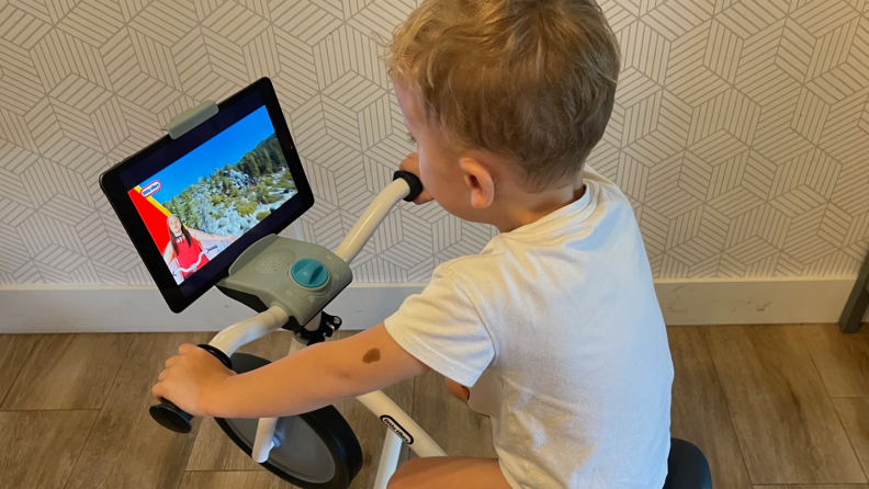 A toddler watching videos on an iPad.