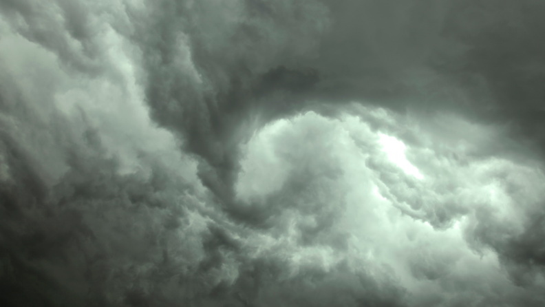 Green and gray colored storm clouds forming a funnel cloud