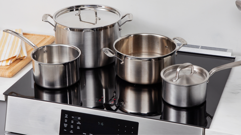 Assorted pots and pans on the cooktop of the Bosch HII8057U 800 Series Induction Slide-in Range.