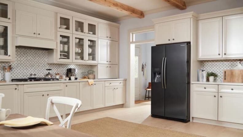 The Samsung RS25J500DSR side-by-side refrigerator, installed in a bright, modern kitchen.